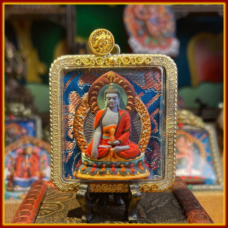 This is a Buddha amulet made of clay by artisans on the roof of the world. It was fired at high temperatures and then hand-painted with mineral pigments. Its name is Akshobhya Buddha.
