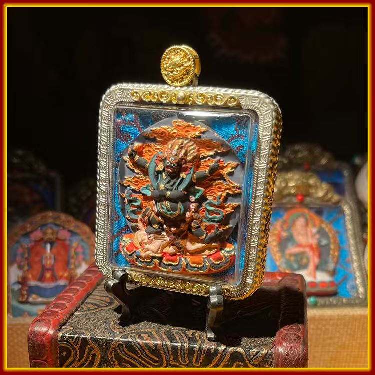 This is a Buddha amulet made of clay by artisans on the roof of the world. It was fired at high temperatures and then hand-painted with mineral pigments. Its name is the Four-Armed Vajra Conqueror.