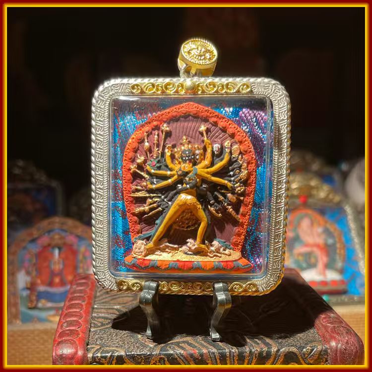 This is a Buddha amulet made of clay by artisans on the roof of the world, fired at high temperatures, and then hand-painted with mineral pigments. Its name is Chakrasamvara.