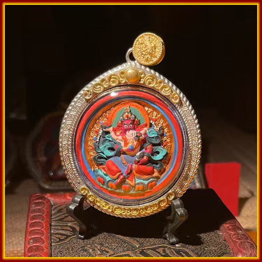 These are amulets made of clay by artisans on the roof of the world, fired at high temperatures and hand-painted with mineral pigments. His name is Red Jambhala.