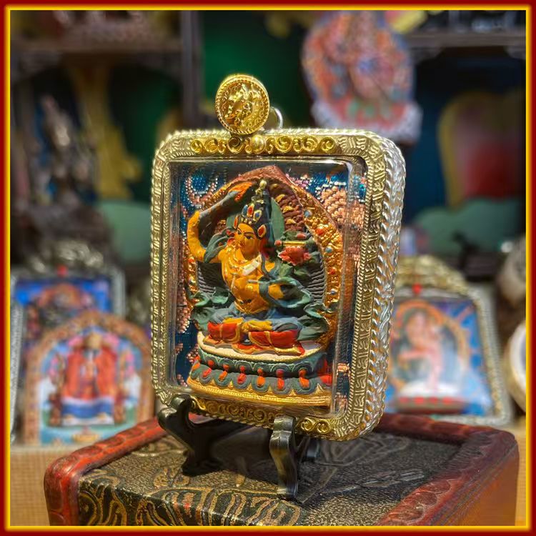 This is a Buddha amulet made of clay by artisans on the roof of the world, fired at high temperatures, and then hand-painted with mineral pigments. Its name is Manjushri Bodhisattva.