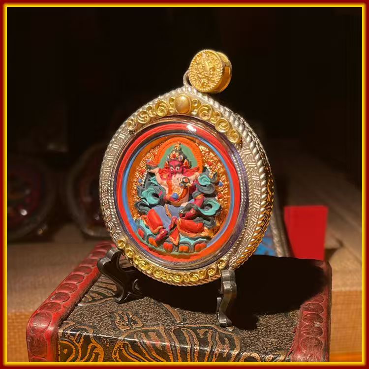 These are amulets made of clay by artisans on the roof of the world, fired at high temperatures and hand-painted with mineral pigments. His name is Red Jambhala.