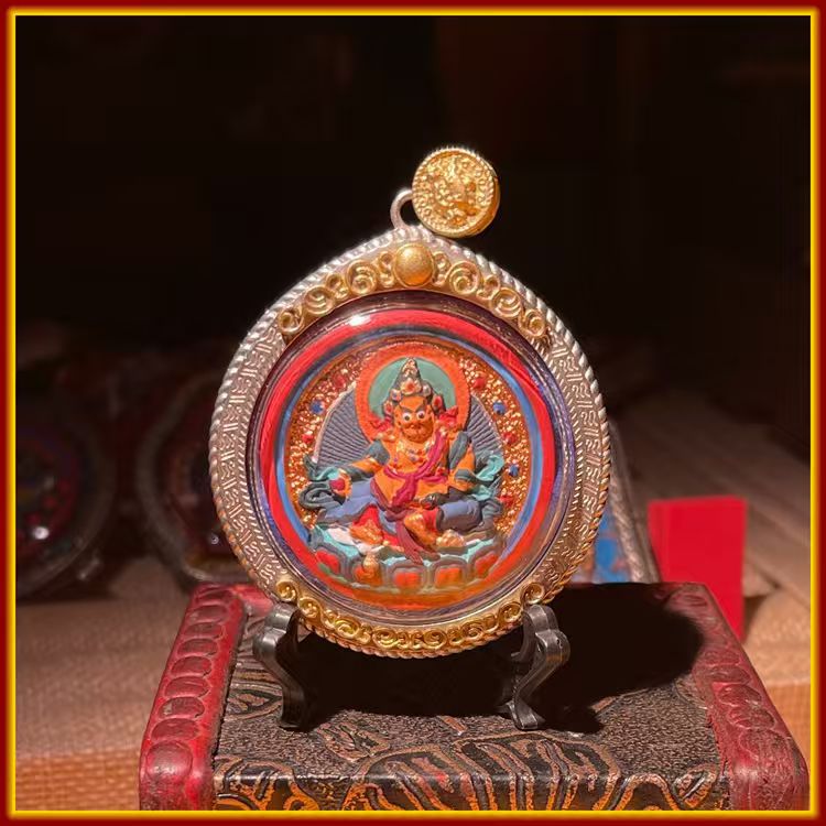 This is a Buddha amulet made of clay by artisans on the roof of the world, fired at high temperatures, and hand-painted with mineral pigments. Its name is Yellow Jambhala.