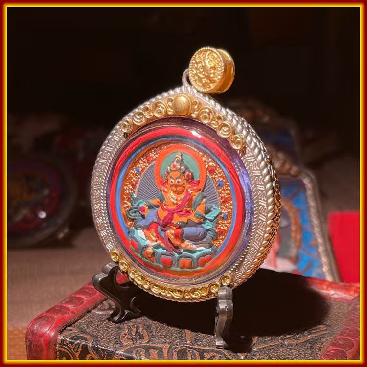 This is a Buddha amulet made of clay by artisans on the roof of the world, fired at high temperatures, and hand-painted with mineral pigments. Its name is Yellow Jambhala.