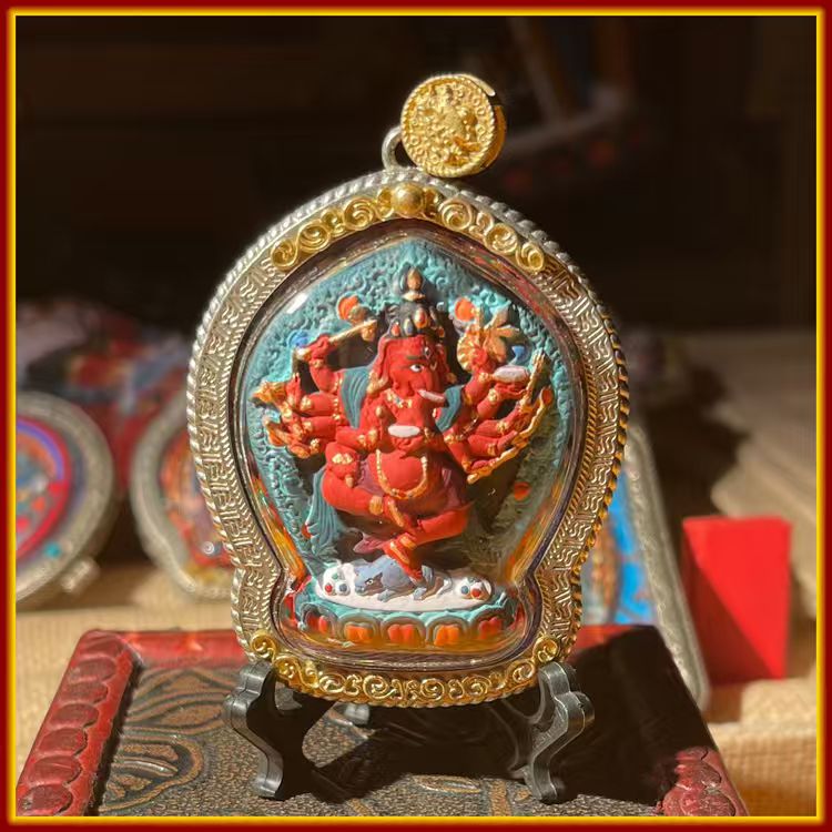 This is a Buddha amulet made of clay by artisans on the roof of the world, fired at high temperatures, and hand-painted with mineral pigments. Its name is "Red Elephant-Trunked God of Wealth".