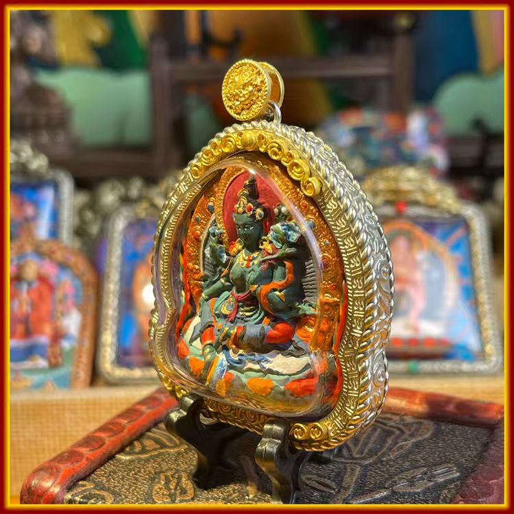 This is a Buddha amulet made of clay by artisans on the roof of the world, fired at high temperatures, and then hand-painted with mineral pigments. Its name is Green Tara.