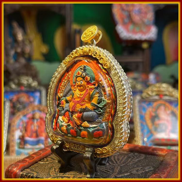 This is a Buddha amulet made of clay by artisans on the roof of the world, fired at high temperatures, and hand-painted with mineral pigments. Its name is Yellow Jambhala.