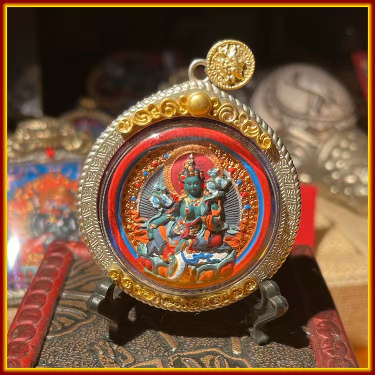 This is a Buddha amulet made of clay by artisans on the roof of the world, fired at high temperatures, and hand-painted with mineral pigments. Its name is White and Green Tara.