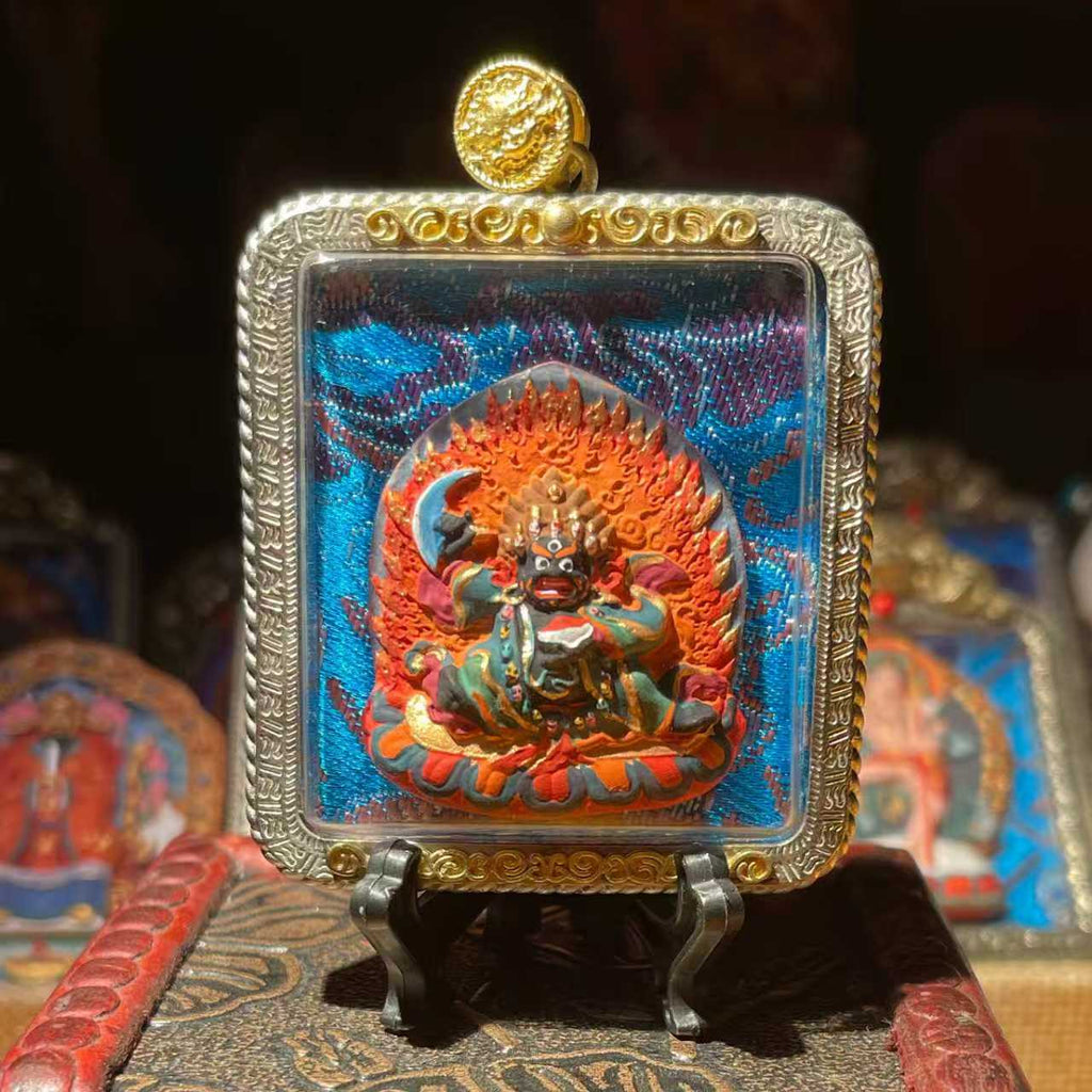 This is a Buddhist amulet made of clay by artisans on the roof of the world, fired at high temperatures, and then hand-painted with mineral pigments. Its name is Black Robe Vajra.