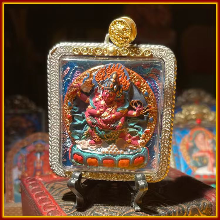 This is a Buddha amulet handcrafted from clay by artisans on the roof of the world. It was fired at high temperatures and then hand-painted with mineral pigments. Its name is "Red Jambhala".