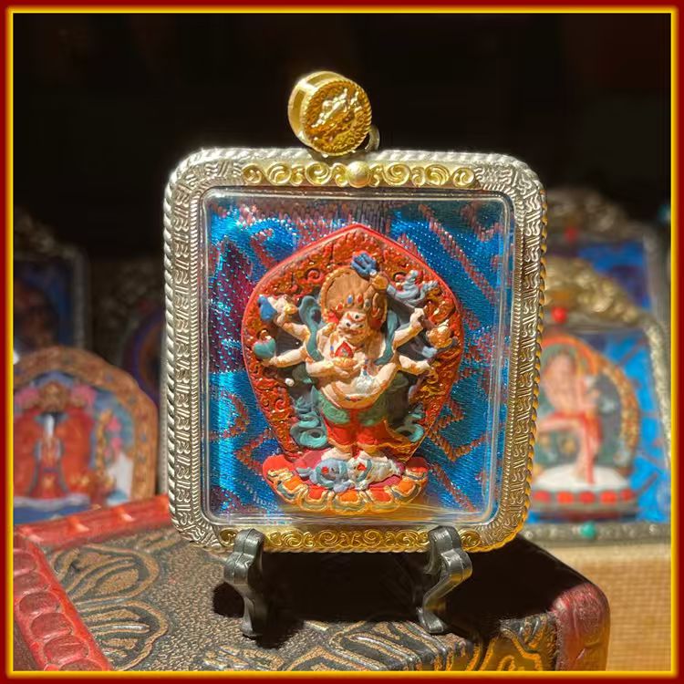This is a Buddha amulet made of clay by artisans on the roof of the world. It was fired at high temperatures and then hand-painted with mineral pigments. Its name is White Six-Armed Mahakala.