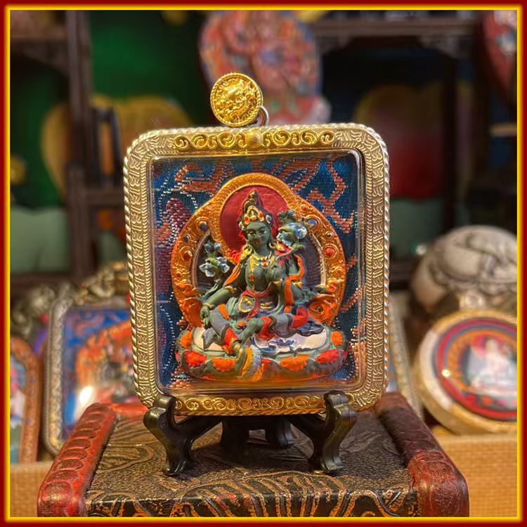 This is a Buddha amulet made of clay by artisans on the roof of the world, fired at high temperatures, and then hand-painted with mineral pigments. Its name is Green Tara.