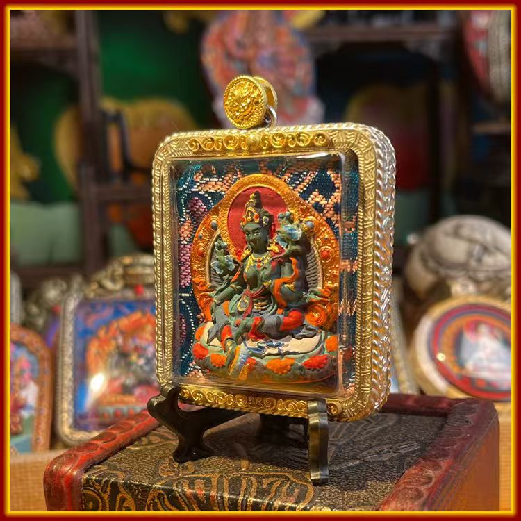 This is a Buddha amulet made of clay by artisans on the roof of the world, fired at high temperatures, and then hand-painted with mineral pigments. Its name is Green Tara.