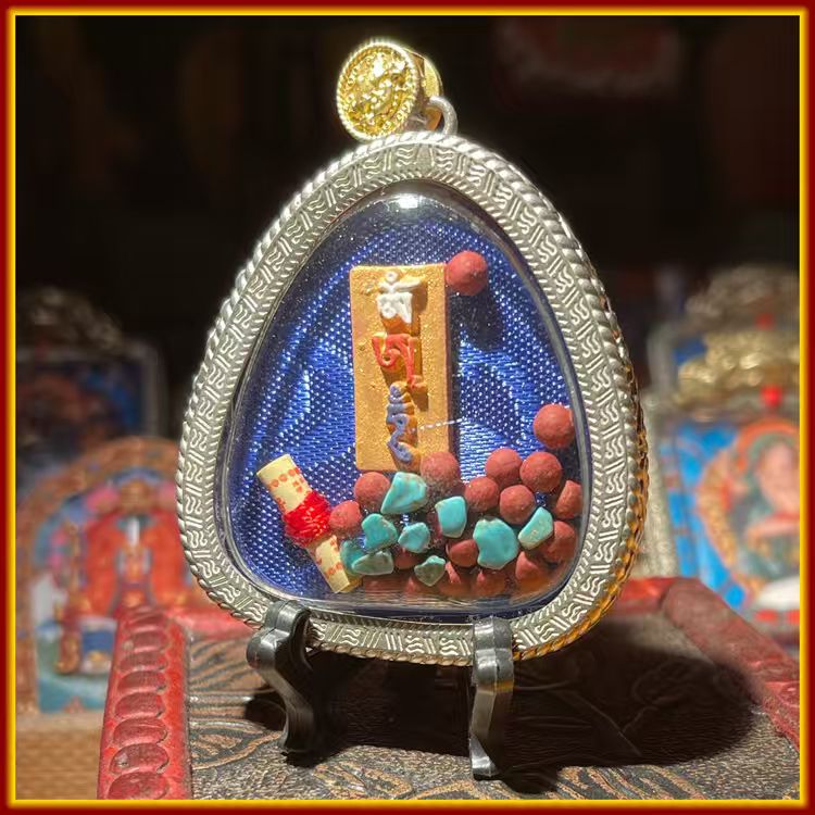 This is a Buddha amulet made of clay by artisans on the roof of the world, fired at high temperatures, and then hand-painted with mineral pigments. Its name is Zhaqilam.