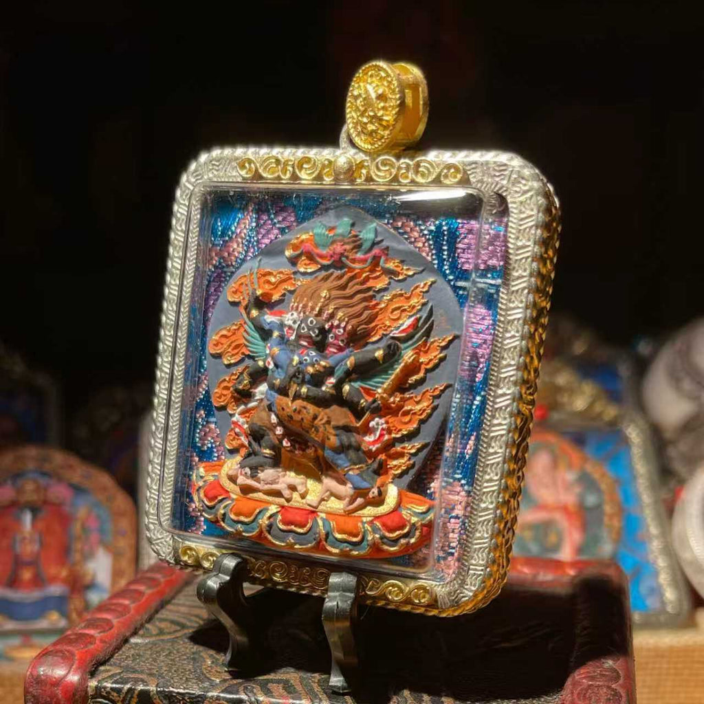 This is a Buddhist amulet made of clay by artisans on the roof of the world, fired at high temperatures, and then hand-painted with mineral pigments. Its name is Vajrakilaya.