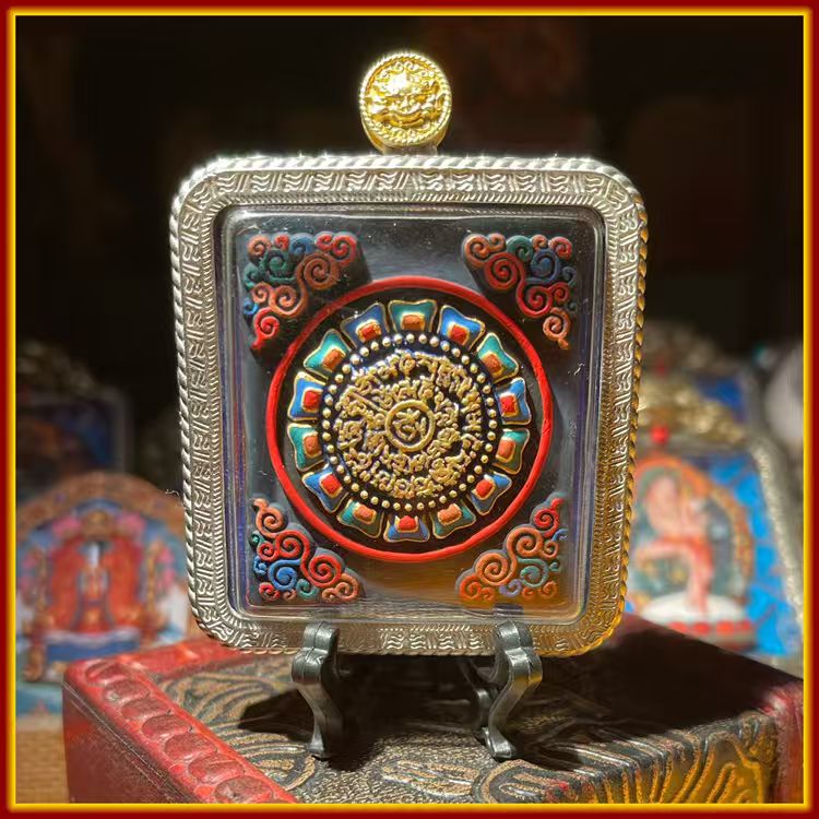 This is a Buddha amulet handcrafted from clay by artisans on the roof of the world. It was fired at high temperatures and then hand-painted with mineral pigments. Its name is "Red Jambhala".