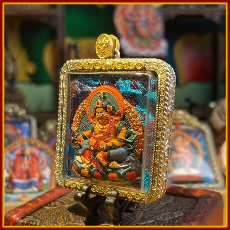This is a Buddha amulet made of clay by artisans on the roof of the world, fired at high temperatures, and hand-painted with mineral pigments. Its name is Yellow Jambhala.