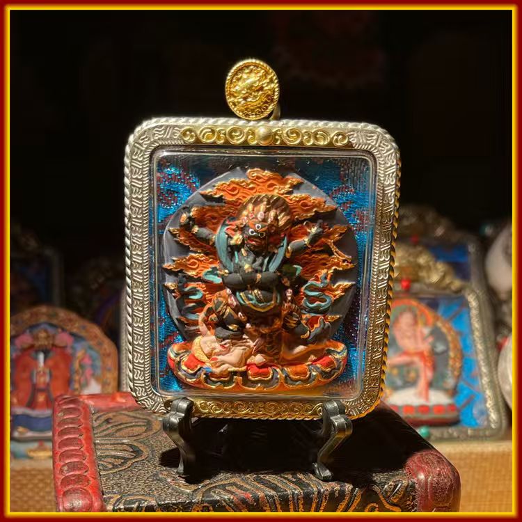 This is a Buddha amulet made of clay by artisans on the roof of the world. It was fired at high temperatures and then hand-painted with mineral pigments. Its name is the Four-Armed Vajra Conqueror.