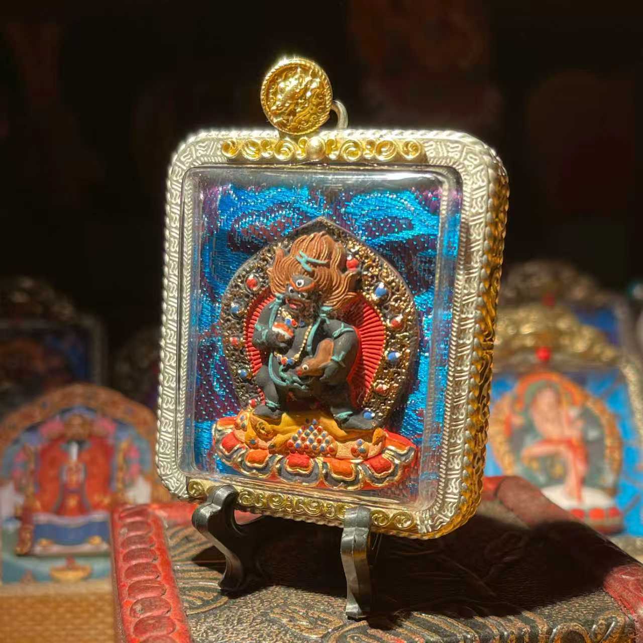 This is a Buddha amulet made of clay by artisans on the roof of the world, fired at high temperatures, and hand-painted with mineral pigments. Its name is Black Jambhala.